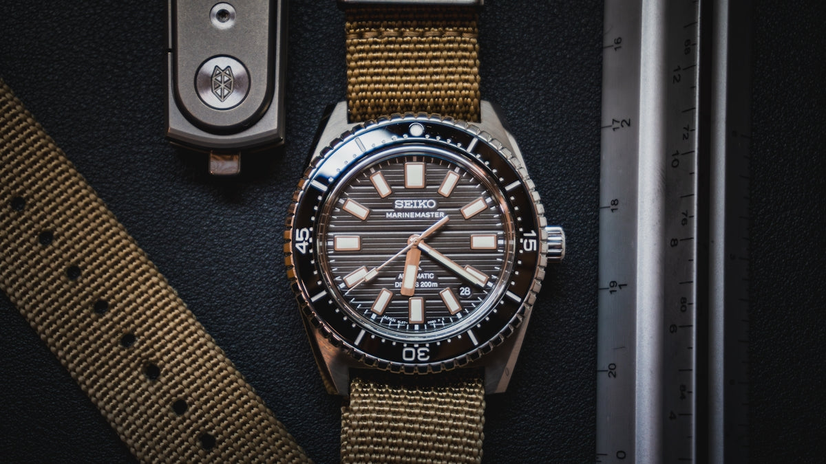 A watch sitting on top of a table next to a watch strap