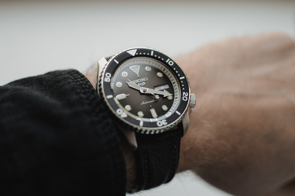 A wrist displays a stylish watch.