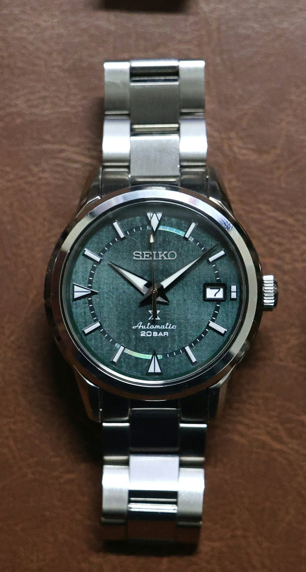 Seiko automatic watch with green textured dial.